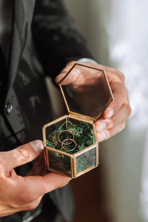 wedding rings lie in a beautiful glass box on green moss. Details of the verb during the morning...