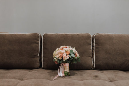 A wedding bouquet of various roses on a brown sofa. Free space.の写真素材