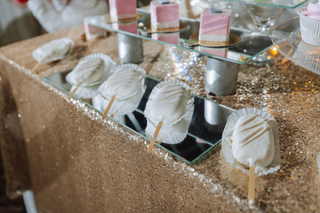 A sweet table at a wedding. Table with cakes and sweets at the festival. Birthday sweets