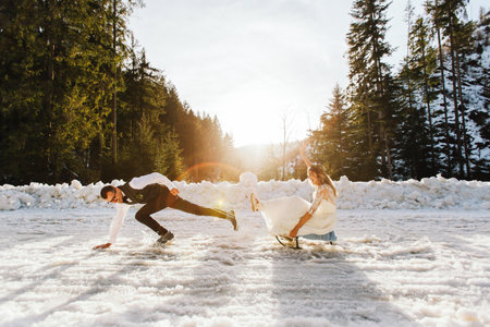 The bride and groom ride a sleigh on a snowy road in winter. Winter wedding on the street in the...