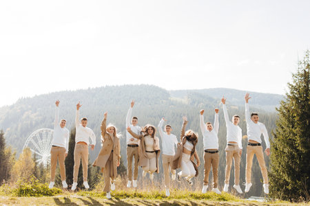 friendship, movement, action, freedom and people concept - group of happy teenagers or school friends jumping and having fun outdoors on the background of a beautiful place.の写真素材