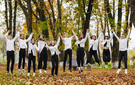 friendship, movement, action, freedom and people concept - group of happy teenagers or school...