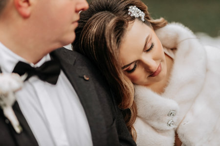 Wedding couple in love. A beautiful bride and an elegant groom tenderly embrace and enjoy the day. A...