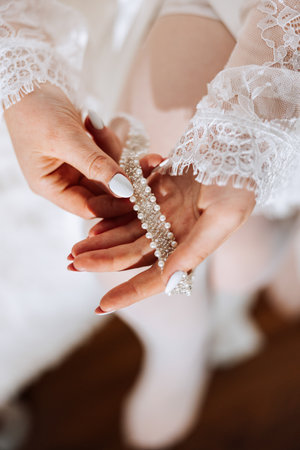 Details of the bride. Beauty is in the details. High-heeled bridal shoes. Gold wedding ring with a...