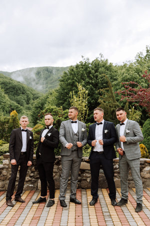 Cheerful, young, energetic witnesses of the groom next to the groom. Friends congratulate the groom....
