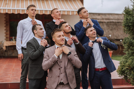 Cheerful, young, energetic witnesses of the groom next to the groom. Friends congratulate the groom....