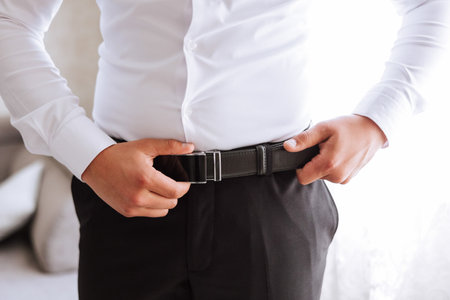 The morning of the groom, the groom prepares for the wedding ceremony, dresses in a suit and shoes....