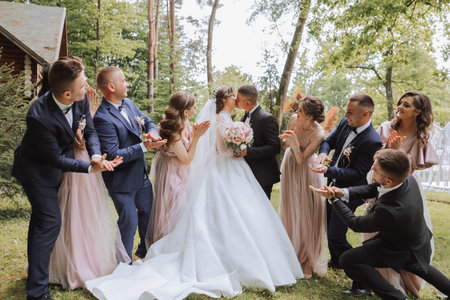 full-length portrait of the newlyweds and their friends at the wedding. The bride and groom with bridesmaids and friends of the groom are having fun and rejoicing at the wedding.の写真素材