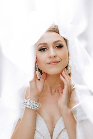 Beautiful bride with wedding flowers bouquet, attractive woman in wedding dress. Happy newlywed woman. Bride with wedding makeup and hairstyle. Smiling bride. Wedding day. Gorgeous bride. Marriage.の写真素材