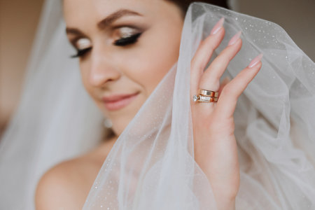 Beautiful bride with wedding flowers bouquet, attractive woman in wedding dress. Happy newlywed woman. Bride with wedding makeup and hairstyle. Smiling bride. Wedding day. Gorgeous bride. Marriage.の写真素材