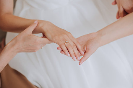 tender hands of a young woman with an expensive ring and a beautiful manicure. Close-up photo of female handsの写真素材