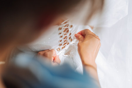 close-up of female hands touching dress. Women's manicure. A luxurious wedding ring on a woman's finger.の写真素材