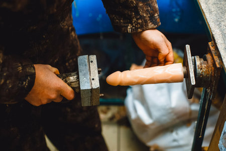 Processing of rubber products for sex shop on the machine. Mold for the product. Rubber penis
