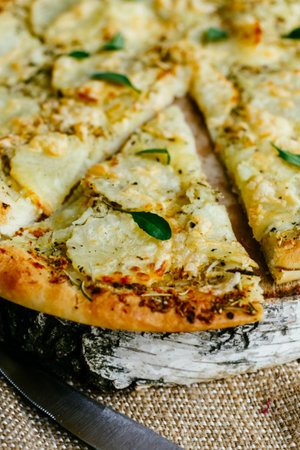 A slice of pizza separated from the main part of the pizza.の写真素材