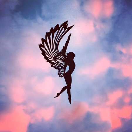 girl angel with wings made of paper. figurine against the sky. figurines carved from paper in a photo of the sky.の写真素材