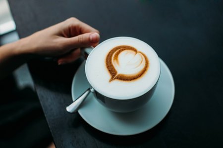 A cup of coffee with a foam in the form of a heart. Coffee with foam.の写真素材