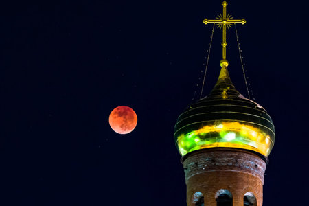 The dome of the church against the red moon. lunar eclipse.