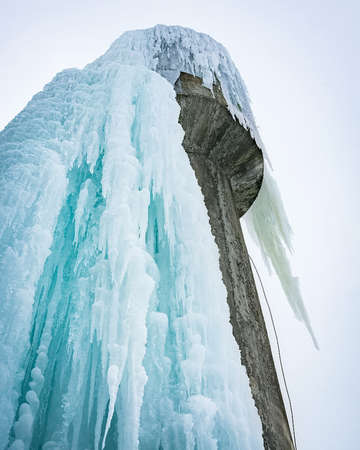 icicles on the water tower, the water froze on the water pump.の写真素材