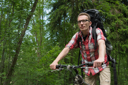 Confident young man on the bike forward-looking  Copy space   Concept of the right way  の写真素材