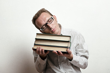 Tired sleeping student lay his head on the old big booksの写真素材