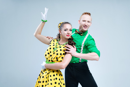 Portrait lovely funny dancer couple dressed in boogie-woogie rock n roll pin up styleの写真素材