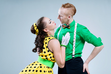 Portrait lovely funny dancer couple dressed in boogie-woogie rock n roll pin up style posing together in studio の写真素材