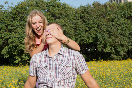 Girlfriend covering the eyes of his boyfriend for a surpriseの写真素材