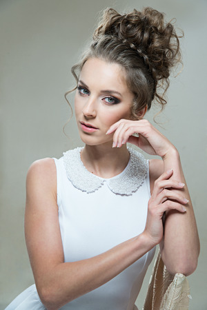 Glamour lady portrait in luxury dress. Beautiful model girl with perfect fashion makeup and hairstyle.の写真素材