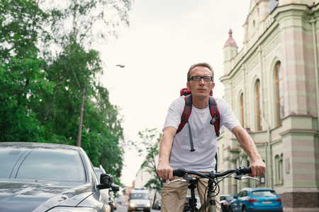 tourist man on a bike at old city streetの写真素材