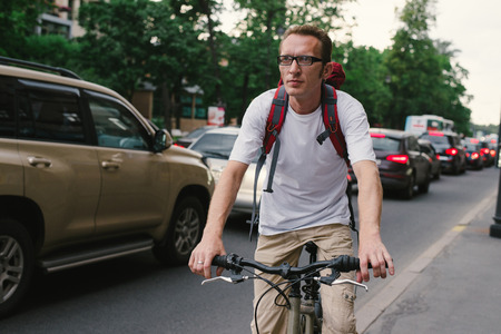 tourist man on a bike at old city streetの写真素材