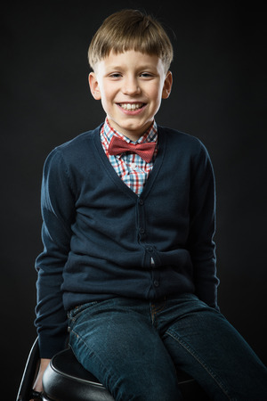Close up portrait of young smiling cute boy in bow tieの写真素材