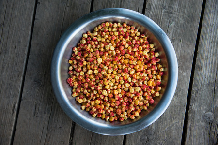 bowl with cloudberries on the wooden tableの写真素材