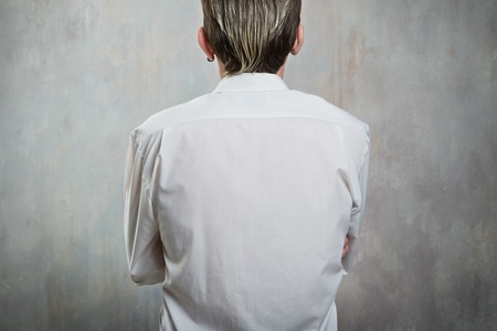 man back view in white shirt and arms crossの写真素材