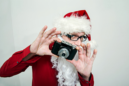 Santa Claus makes photo on retro cameraの写真素材
