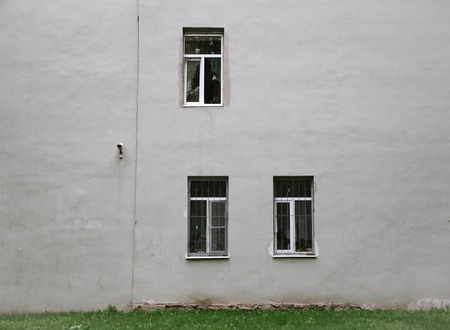 gray wall with three windows and gtass lineの写真素材