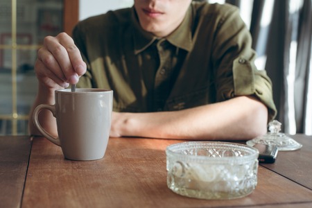 man drinking tea on the wooden tableの写真素材
