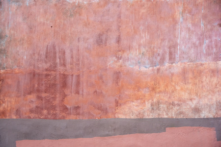 Pink multicolored weathered outdoor wall. Urban textured background.の写真素材