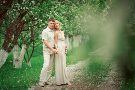 Beautiful cuople are standing in apple tree gardenの写真素材