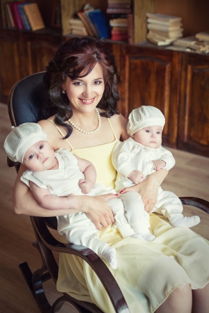 Young beautiful mother with her dougthersの写真素材