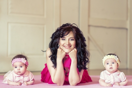 Young beautiful mother with her dougthersの写真素材