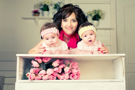 Young beautiful mother with her dougthersの写真素材