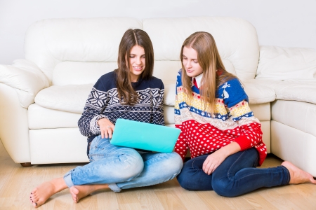 Two beautiful girls with a laptopの写真素材