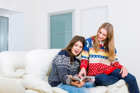 Two girls are reading magazineの写真素材