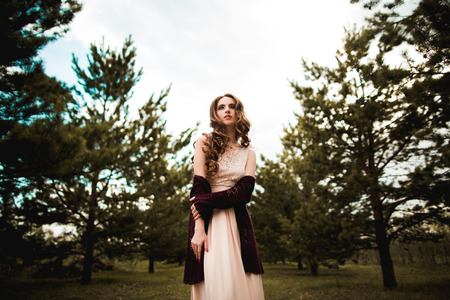 Sensual girl in pink dress in forestの写真素材