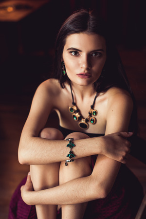 closeup shot of young brunette model posing in burlesque fitting roomの写真素材