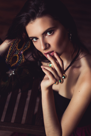 closeup shot of young brunette model posing in burlesque fitting roomの写真素材