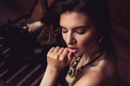 closeup shot of young brunette model posing in burlesque fitting roomの写真素材
