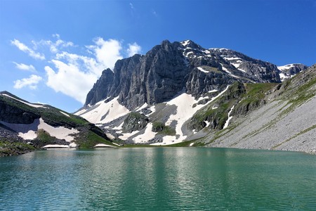 Astraka Astraka peak raises behind alpine glacier lake Kseroloutsa in Tymfi, Greece. This picture is rare as Kseroloutsa has usually much less water and dries out completely in summer months.の写真素材