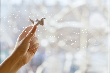 Fabulous paper crane in your handの写真素材