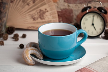 Cup of tea and biscuits on a background of a brick wall.の写真素材